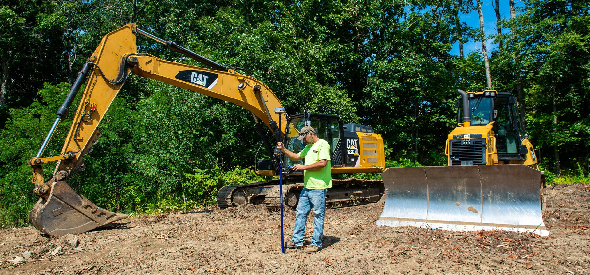 Man Standing Near a Backhoe
